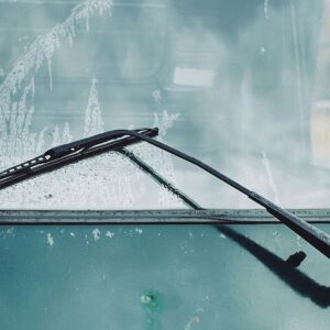 Windshield wipers wiping a windshield.